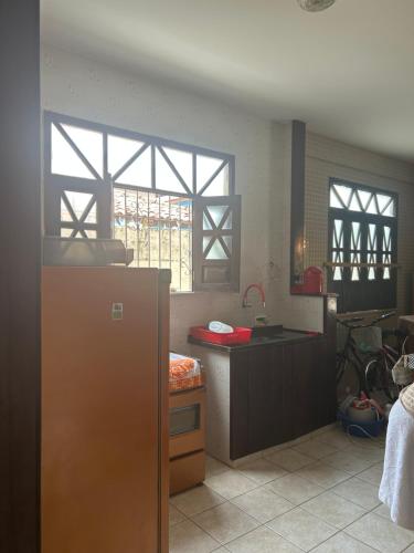 a kitchen with a sink and a refrigerator at Casa de veraneio in Salinópolis