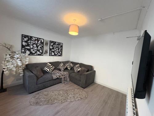 a living room with a couch and a flat screen tv at Stag Do accommodation, central Bournemouth in Bournemouth