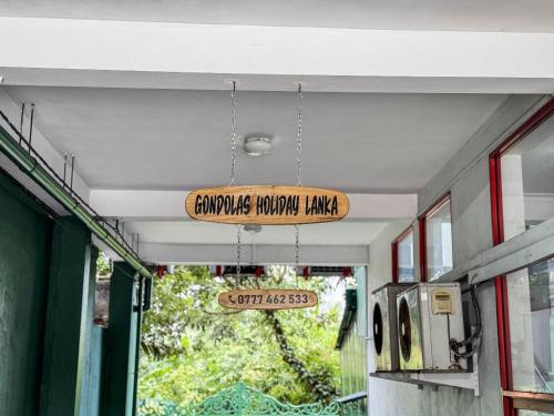 a sign hanging from the ceiling of a building at Gondolas Hotel Stay in Ragama