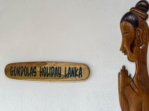 a wooden stick with the words colombia hollywoodianeiane sidx at Gondolas Hotel Stay in Ragama