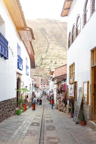 a street in a town with a mountain in the background at Ayra Hotel Boutique in Pisac