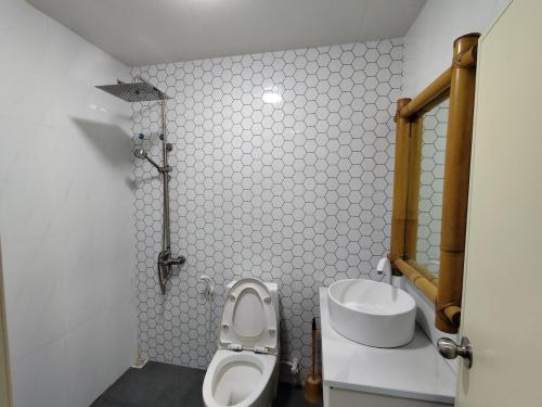 a small bathroom with a toilet and a sink at Hidden Reef Retreat 