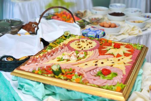 a large cake on a table with food on it at ZOO hotel in Osijek
