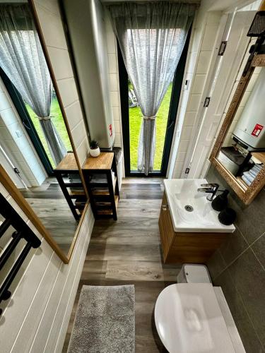 a bathroom with a toilet and a sink and a mirror at Namiņš atpūtai in Liepāja