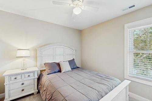 a bedroom with a bed and a dresser and a window at Beaufort Villas #B in Beaufort