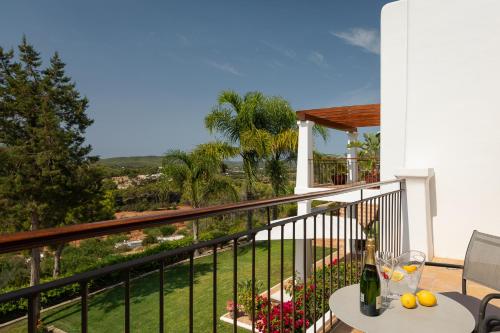 a balcony of a house with a table and wine bottles at New! Villa Llosas de Dalt in Sant Carles de Peralta