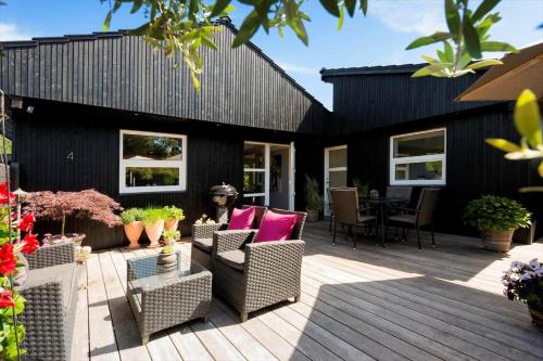 an outdoor patio with chairs and a table at 30074-Malling-Musvitvej-4 in Malling