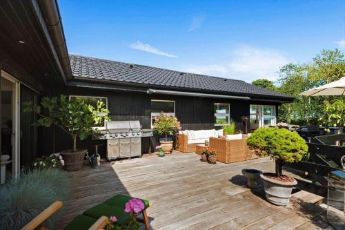 a backyard with a wooden deck with potted plants at 30074-Malling-Musvitvej-4 in Malling