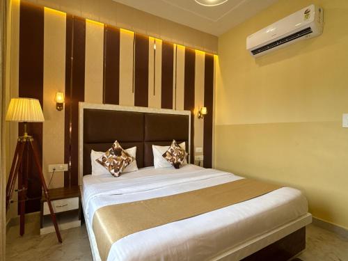 a bedroom with a large bed in a room at The Orchid Retreat in Agra