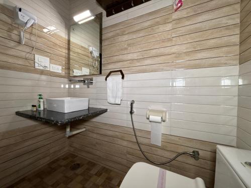 a bathroom with a sink and a toilet in it at The Orchid Retreat in Agra