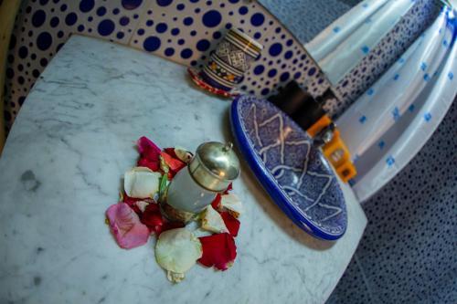 a table with a plate of food and a bottle of wine at Dar Lalamoune in Fès
