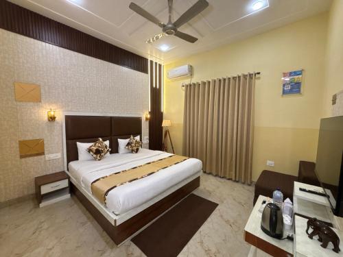 a bedroom with a large bed and a desk at The Orchid Retreat in Agra