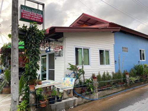 a blue and white building with a sign on it at Yada House twin bed in Nai Yang Beach