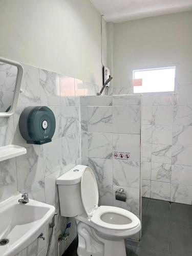 a bathroom with a white toilet and a sink at Yada House Cozy Place in Nai Yang Beach