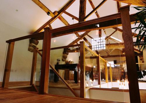 a large glass window in a room with wooden beams at Tithe Barn, Skipton in Skipton