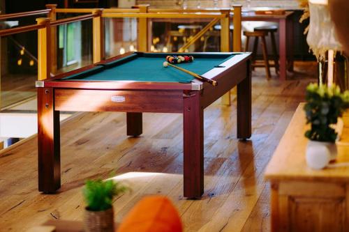 a snooker table with a pool cue on top of it at Tithe Barn, Skipton in Skipton