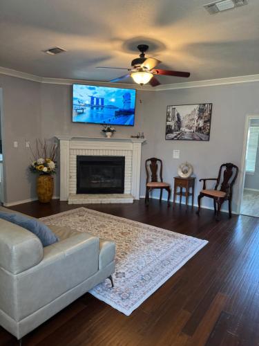 a living room with a couch and a flat screen tv at Exotic Abode - Luxury Double Rooms in Denton