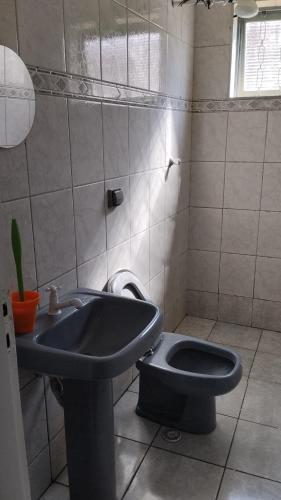 a bathroom with a sink and a toilet at Casa completa para 4 pessoas in Itu