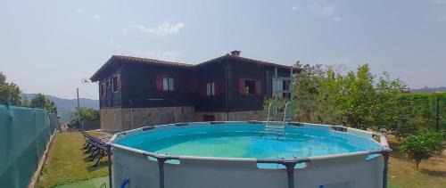 a hot tub in front of a house at Olivar 51 in Villaviciosa