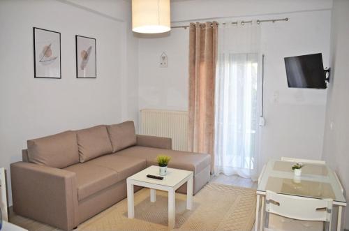 a living room with a couch and a table at Center River Apartment in Florina