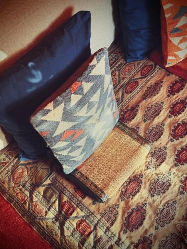 a tie sitting on top of a rug on a bed at CABRA - Porto Covo in Porto Covo