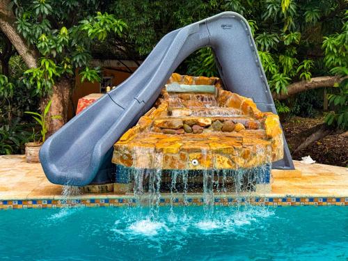 a water slide next to a swimming pool at Caribbean Shores Belize in Hopkins