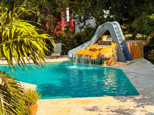 a water slide in a pool in a yard at Caribbean Shores Belize in Hopkins