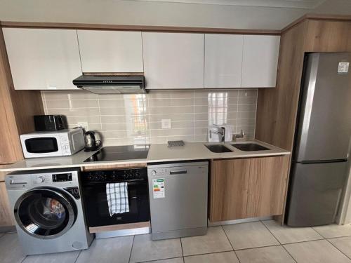 Kuchyň nebo kuchyňský kout v ubytování Cozy abode