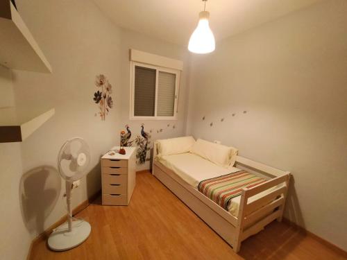 una piccola camera con letto e lampada di Luminoso piso en edificio de canet de berenguer a Canet de Berenguer