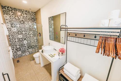 a small bathroom with a sink and a toilet at Privada Stays - Lofts with Private Pool and Oasis, near Eagle Beach in Palm-Eagle Beach