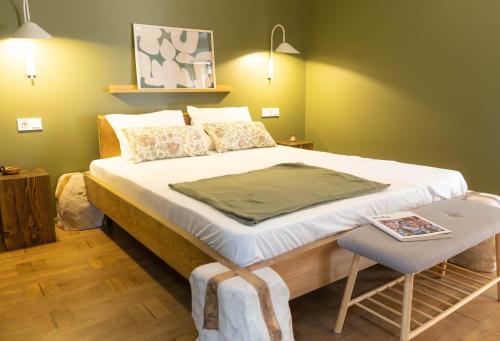 a bedroom with a large bed with a chair at Ruby Hostel - Lux Group Dorm Rooms in Kutaisi