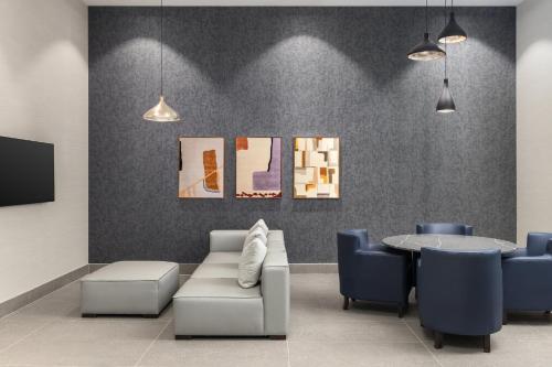 a waiting room with a couch and a table at Staybridge Suites Montreal Airport - St-Laurent by IHG in Montréal