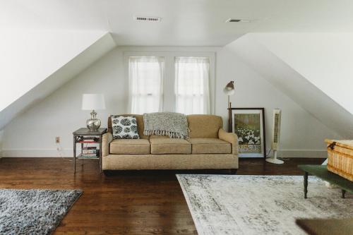 a living room with a couch in a attic at Cozy Oasis by Lake MI with Hot Tub in Harbert