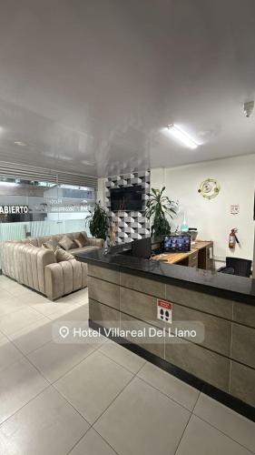 a lobby with couches and a bar in a building at HOTEL VILLAREAL VILLAVICENCiO in Villavicencio