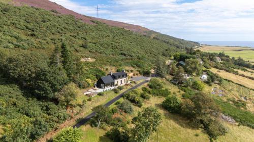 an aerial view of a house on a hill at The Top House, Lothmore in Helmsdale
