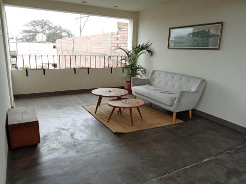a living room with a couch and a table at China Chancay Hotel in Chancay