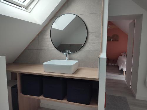 a bathroom with a sink and a mirror on a counter at Maison Louise - Gîte de charme entre forêt et étang - Family friendly 