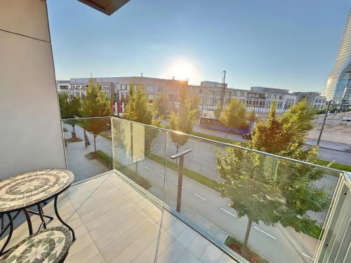 a balcony with a table and a view of a city at BW Sole Dream in Belgrade