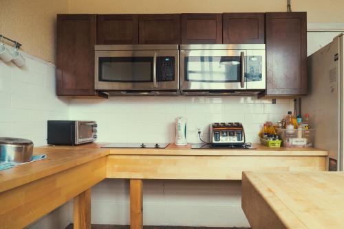 a kitchen with a counter top with a microwave at The Cambie Hostel Gastown in Vancouver