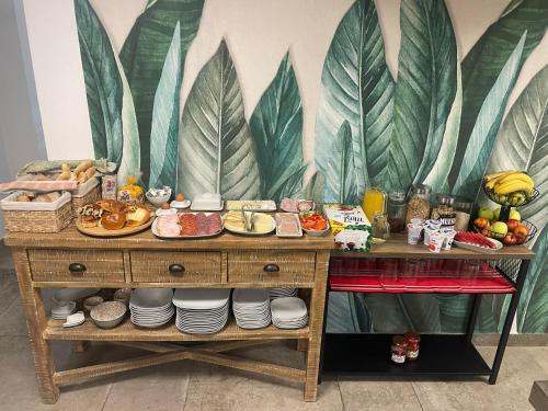 a table with plates of food on it with a mural at Libušina Villa in Kutná Hora