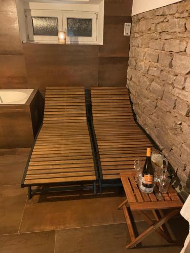two wooden benches sitting in a room with a table at Libušina Villa in Kutná Hora