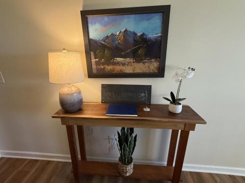 a desk with a lamp and a picture on the wall at Solomon’s Seal - Full Home in Spruce Pine