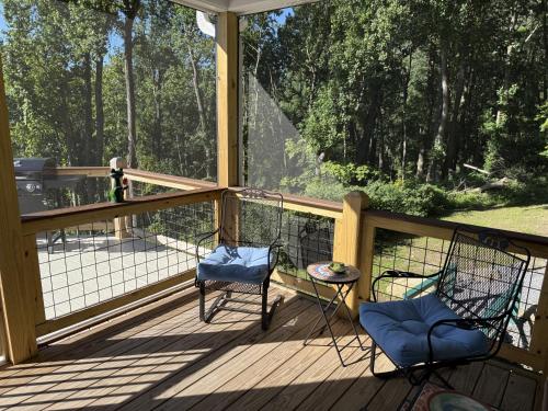 two chairs and a table on a wooden deck at Solomon’s Seal - Full Home in Spruce Pine