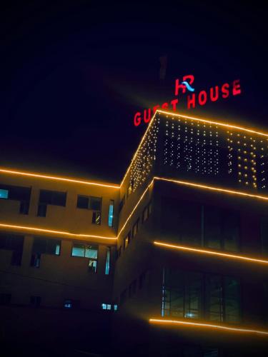 a building with a red sign on top of it at HR Guest House in Gilgit