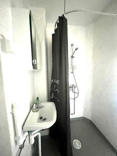 a bathroom with a sink and a shower at Snygg studio lägenhet Wolffskavägen 21 in Vaasa