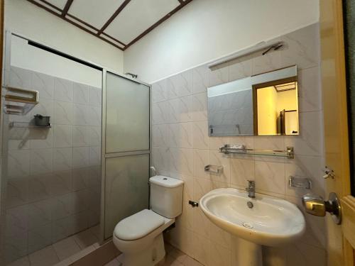 a bathroom with a toilet and a sink at Wonder Apartments in Negombo