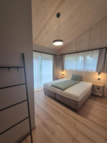 a bedroom with a large bed and a wooden floor at Rofel Zermatt in Zermatt