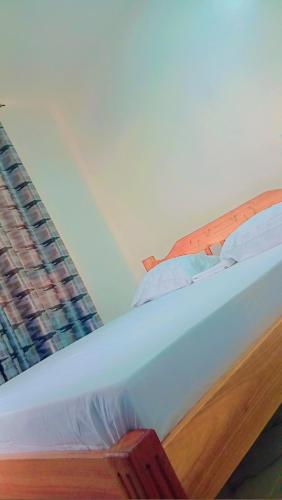 a close up of a bed in a room at Mihambos apartment in Msambweni