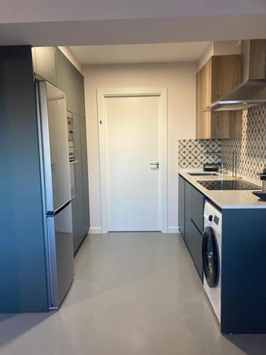 a kitchen with a refrigerator and a washer and dryer at Loft en Aia in Aia
