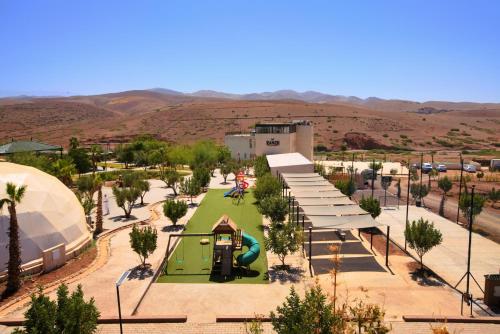 a park with a playground and a slide at The Ranch Camp in El Karia